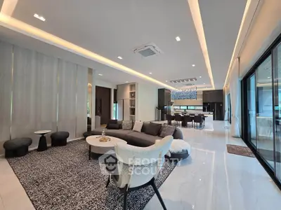 Luxurious open-plan living room with modern furniture and elegant lighting