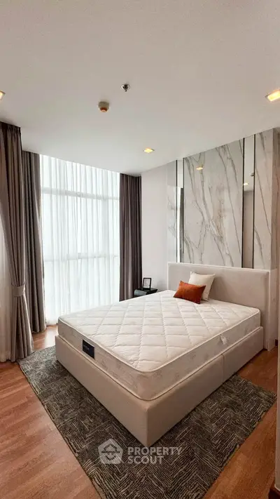 Modern bedroom with large windows and stylish decor