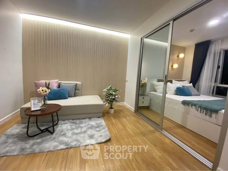Modern living room with cozy seating and stylish bedroom view