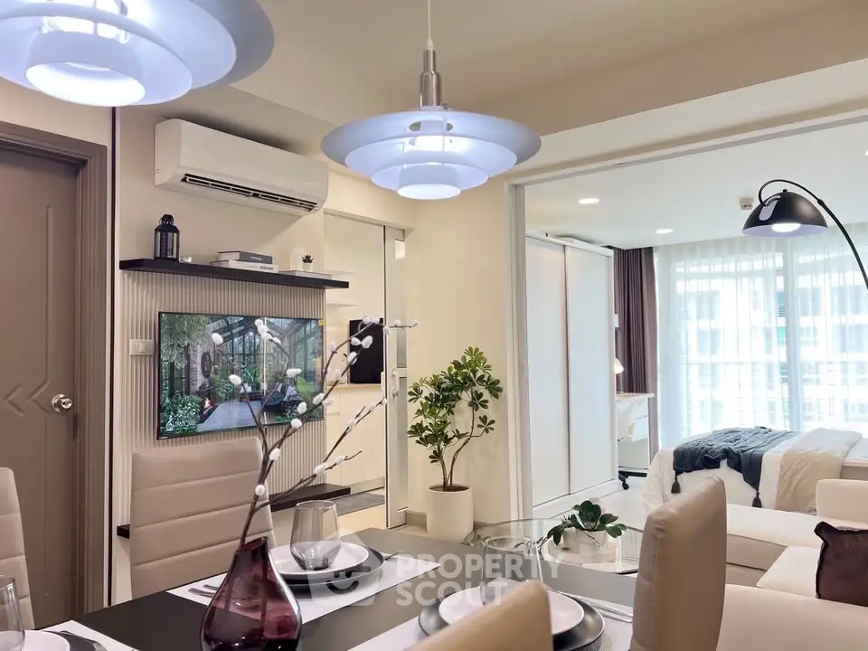 Modern open-plan living room with stylish decor and cozy bedroom view