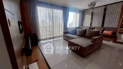 Spacious modern living room with large windows and stylish decor