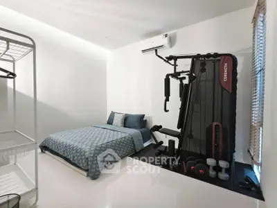 Modern bedroom with gym equipment and minimalist decor