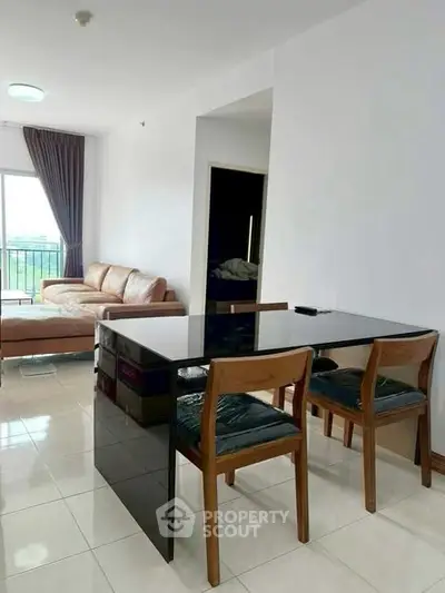 Modern living room with sleek dining area and balcony view