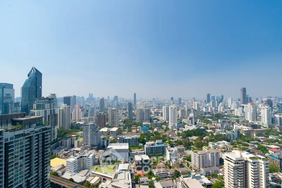 Stunning cityscape view showcasing a vibrant urban skyline with modern high-rise buildings under a clear blue sky.