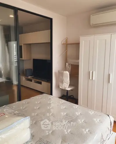 Modern bedroom with sliding glass doors, air conditioning, and stylish furniture.