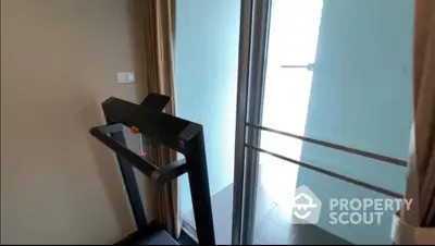 Modern home gym with treadmill and balcony access