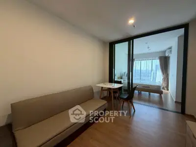 Modern apartment interior with cozy living area and bedroom view