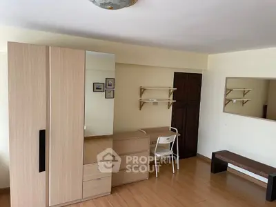 Spacious bedroom with modern wardrobe and study desk, ideal for comfortable living.