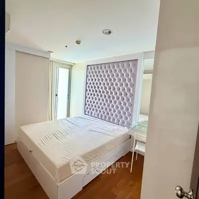 Modern bedroom with stylish padded headboard and natural light