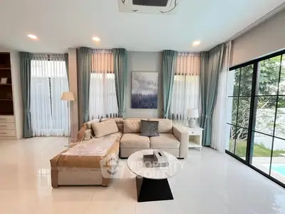 Spacious modern living room with large windows and elegant decor
