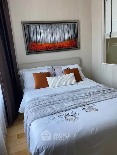 Cozy bedroom with stylish decor and vibrant artwork, perfect for relaxation and comfort.