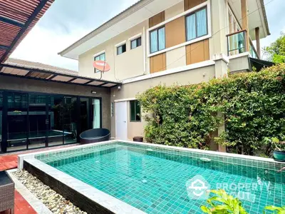 Modern two-story house with private pool and lush greenery, perfect for luxurious living.