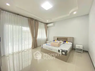 Spacious modern bedroom with large windows and elegant decor