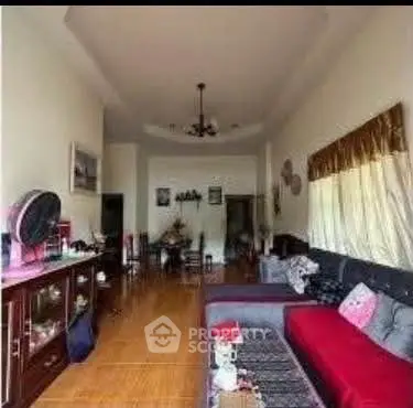 Spacious living room with modern decor and ample natural light.