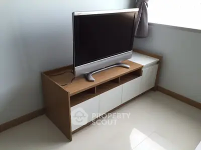 Modern living room corner with sleek TV stand and flat-screen TV
