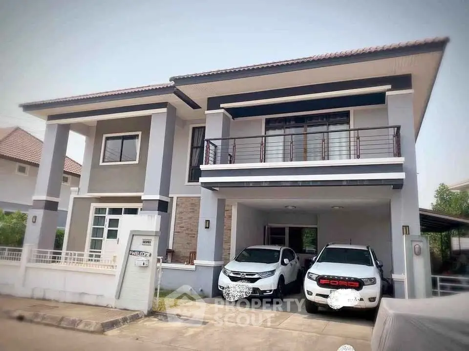 Modern two-story house with spacious driveway and two cars parked, showcasing contemporary architecture.