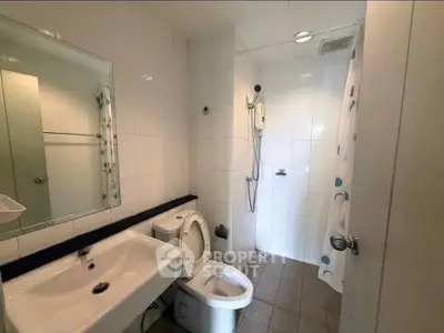 Modern bathroom with shower and sleek fixtures in a contemporary home.