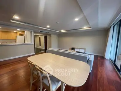 Spacious living room with open kitchen and elegant wooden flooring