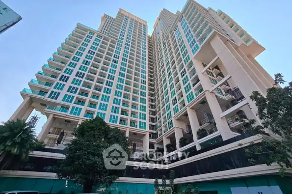 Stunning high-rise building with modern architecture and lush greenery, perfect for urban living.