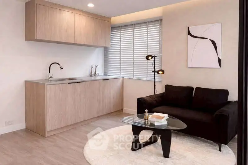 Modern living room with sleek kitchenette and stylish decor