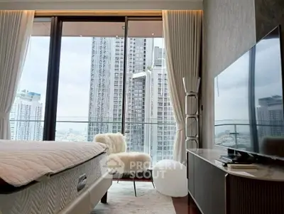 Luxurious bedroom with stunning city view from floor-to-ceiling windows and elegant decor.