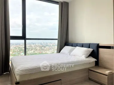 Modern bedroom with panoramic city view from large window, featuring a cozy bed and elegant decor.
