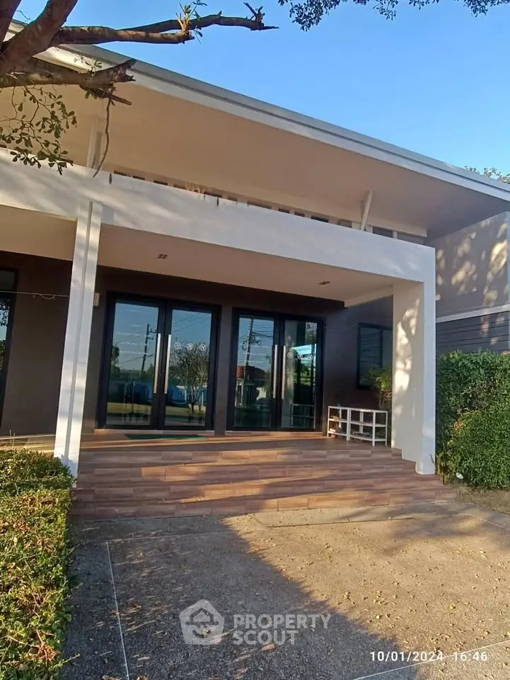 Modern building entrance with large glass doors and clean architectural lines.