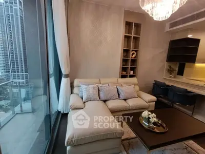 Luxurious modern living room with elegant decor and city view, featuring a plush sectional sofa and stylish lighting.