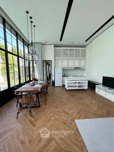 Spacious open-plan living room with elegant dining area and modern kitchen