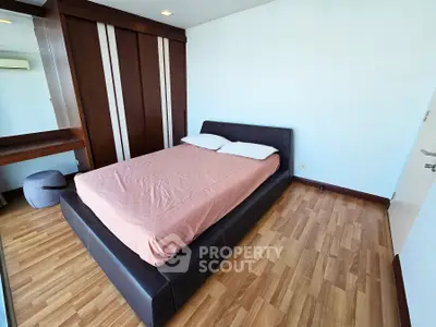 Spacious bedroom with modern design and wooden flooring