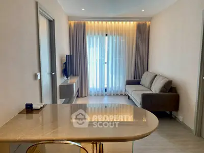 Modern living room with sleek design and natural light, featuring a cozy sofa and elegant decor.