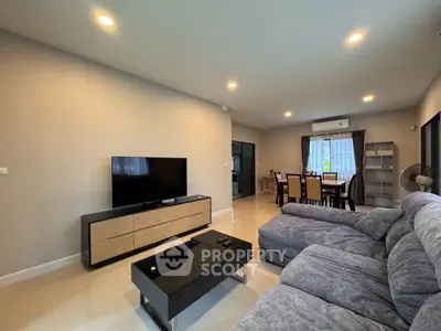Spacious modern living room with sleek furniture and ambient lighting