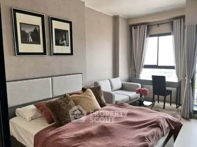 Chic bedroom with cozy bed, stylish decor, and city view window.