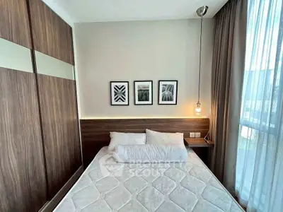 Cozy bedroom with modern decor and large window for natural light