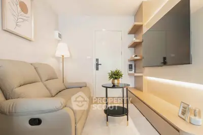 Modern living room with cozy sofa, stylish shelving, and wall-mounted TV in a bright apartment.