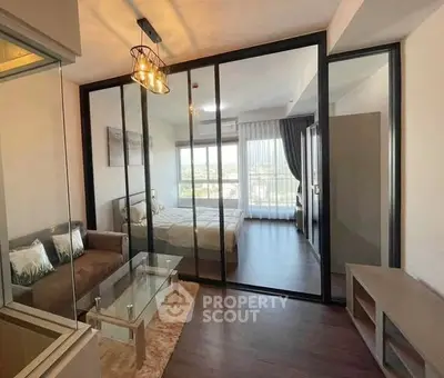 Modern apartment with glass partitioned bedroom and stylish living area