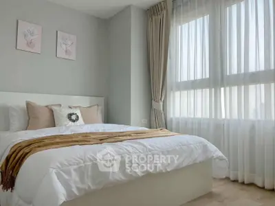 Bright and cozy bedroom with large window and elegant decor