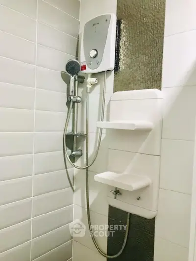 Modern bathroom shower with water heater and sleek tile design.