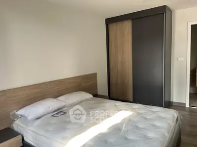 Modern bedroom with sleek wardrobe and comfortable bed in minimalist design.