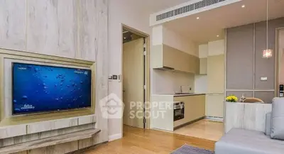 Modern living room with open kitchen, featuring sleek design and built-in appliances for contemporary living.