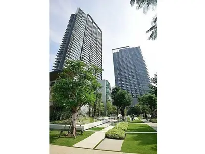 Stunning modern high-rise buildings with lush landscaped gardens in an urban setting.