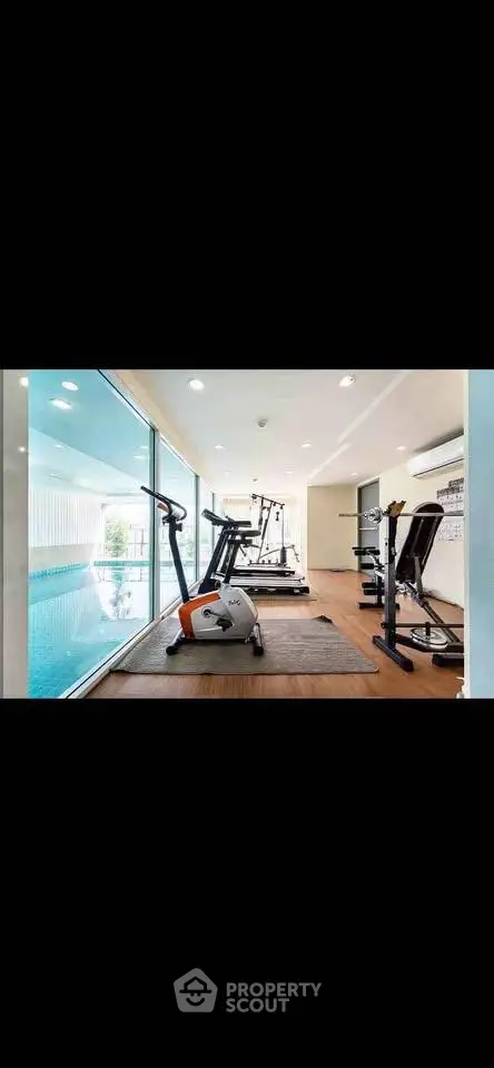 Modern gym with pool view in luxury real estate property