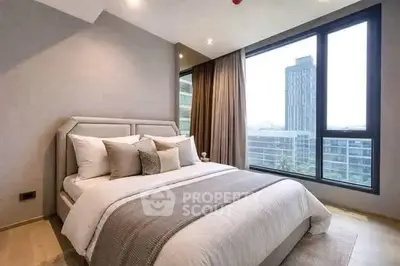 Luxurious bedroom with large windows offering stunning city views, modern decor, and elegant bedding.