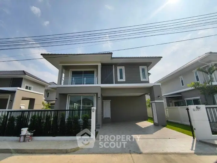 Modern two-story house with spacious driveway and sleek design