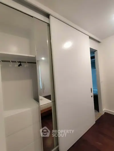 Modern bedroom with sleek sliding closet doors and minimalist design