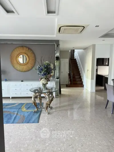 Elegant living room with stylish decor and staircase in modern home