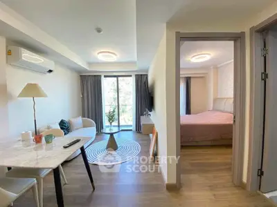 Modern apartment interior with cozy living room and stylish bedroom, featuring natural light and elegant decor.