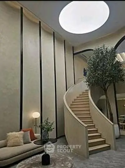 Luxurious modern living room with spiral staircase and indoor tree