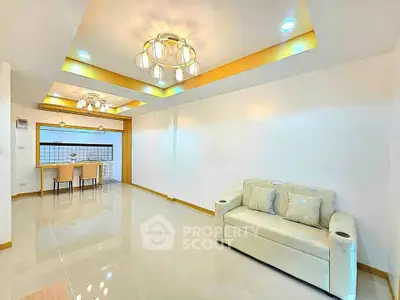 Spacious modern living room with elegant lighting and cozy seating area.