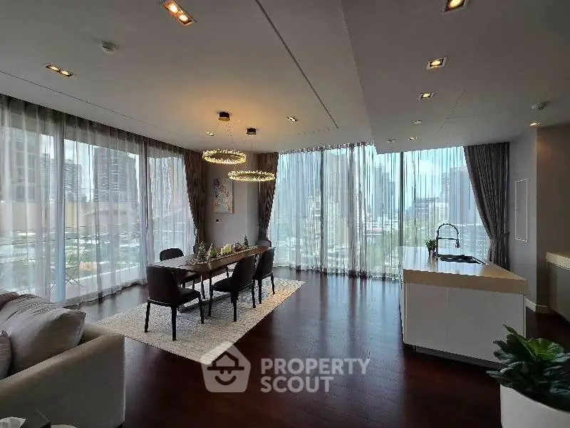 Luxurious corner unit with big living room and open kitchen, featuring floor-to-ceiling windows and city views.